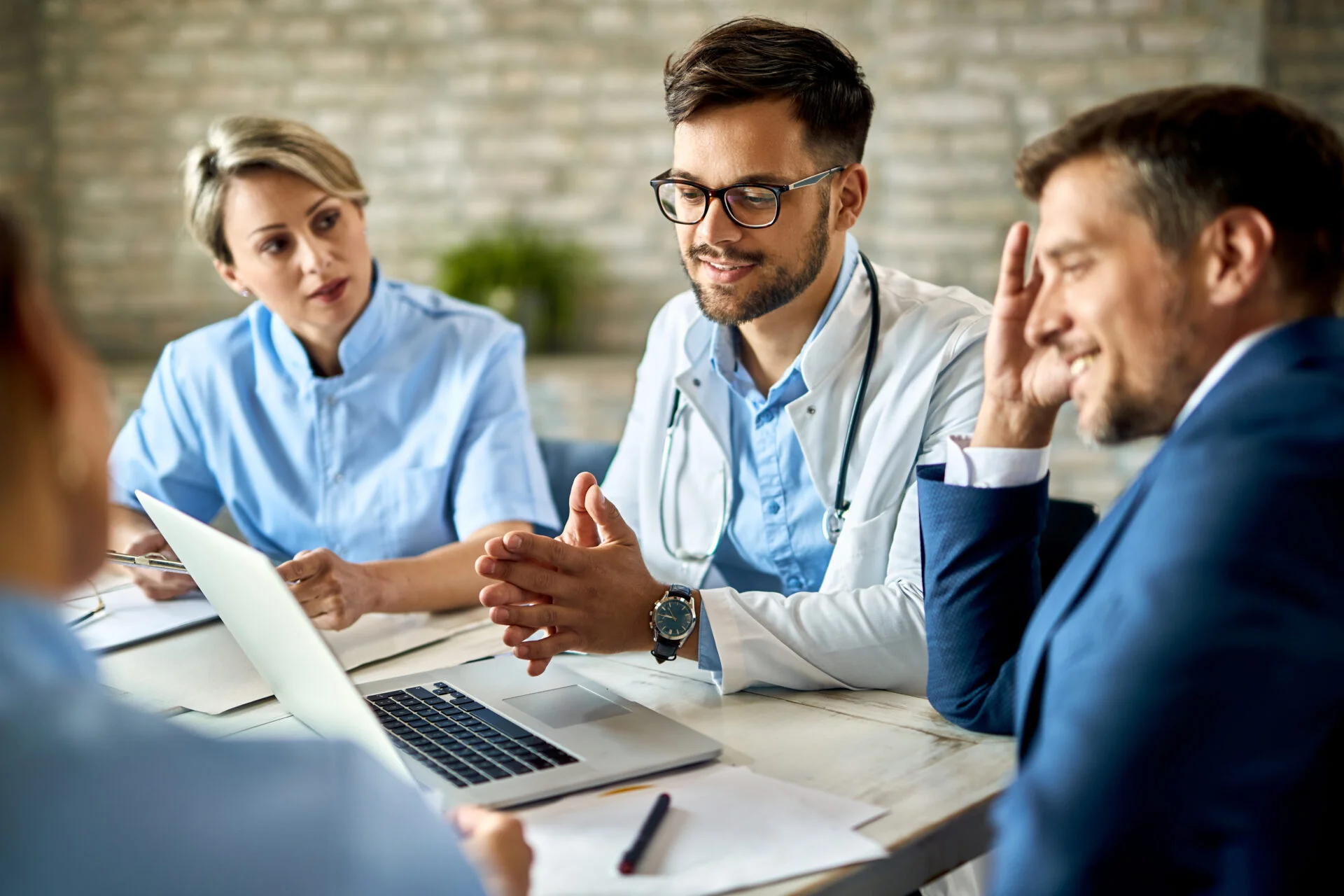 Group of healthcare workers and businessman having a meeting.
